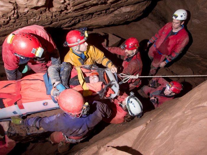 A cave rescue team lifts an injured